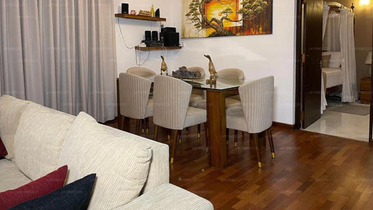 Living room with a sofa and dining area in a home setting