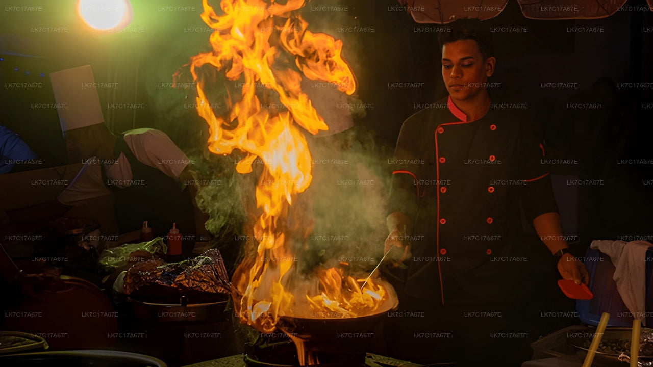 Person cooking over an open flame in a dark setting