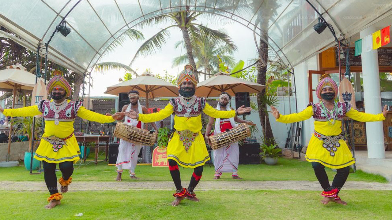Dancers in traditional yellow costumes performing outdoors with palm trees in the background